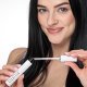 A woman elegantly holds a tube of Nanolash mascara