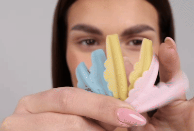 Model applying a silicone rod on her upper eyelid