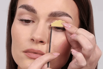 Model taking the rods off out of her eyelids and lashes gently